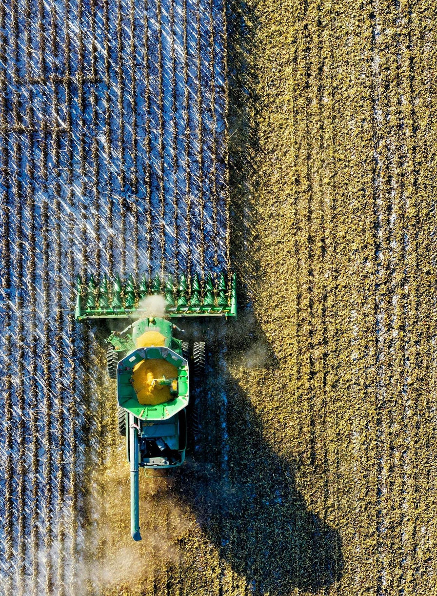 Aerial view of a harvester working a farming property
