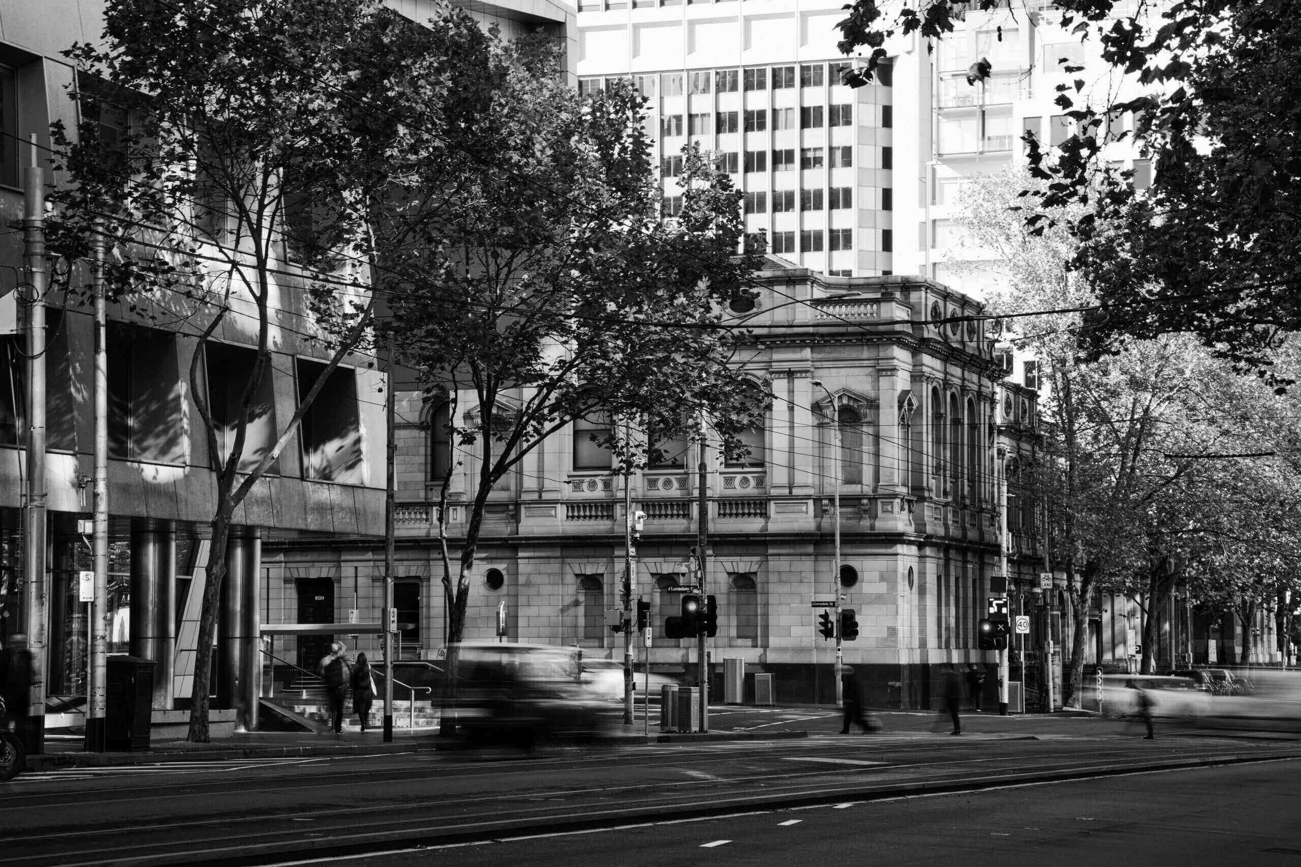 Black and white photo of Melbourne CBD intersection where the Supreme Court and County Court reside.