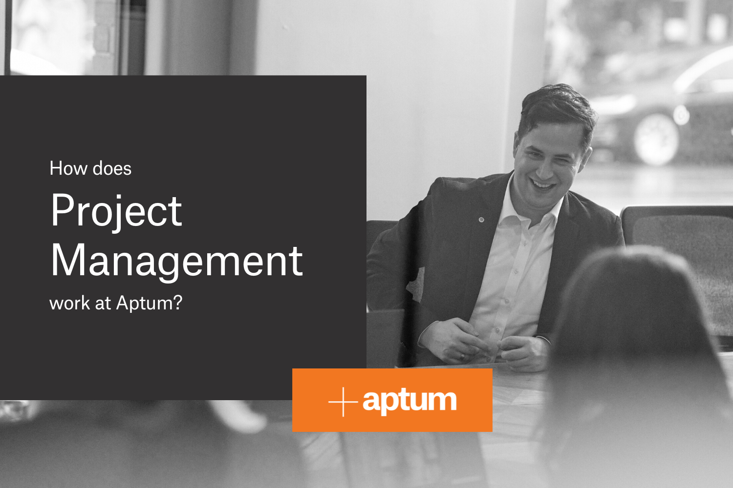 black and white background image of aptum's associate director david adason sitting at boardroom table with text overlaying 'how does project management work at aptum?'