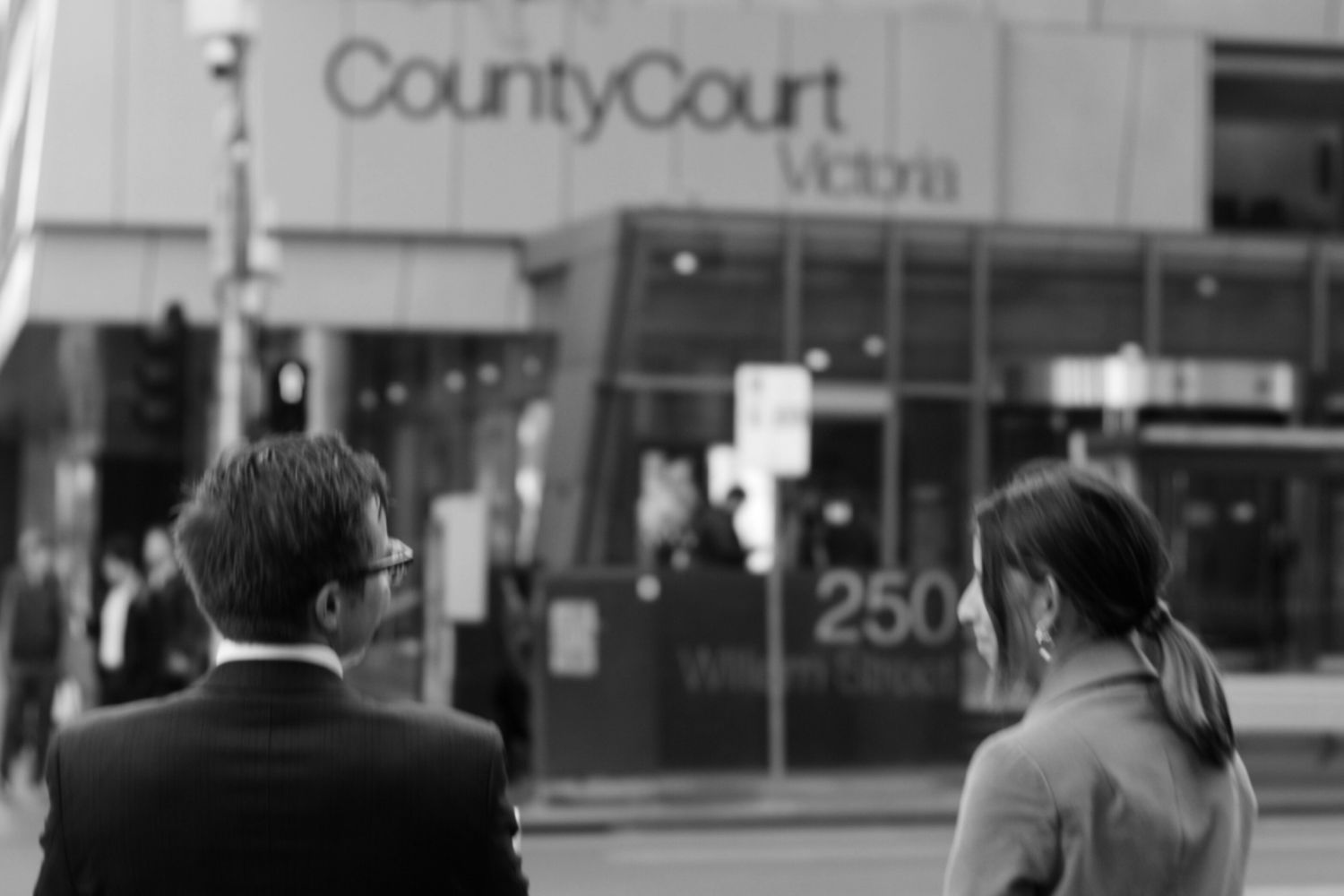 aptum lawyers stand outside the county court of victoria